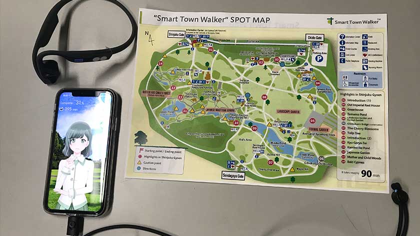 Shinjuku Gyoen smartphone guide app with map and headphones