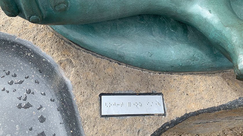 Braille under statue on Mizuki Shigeru Road