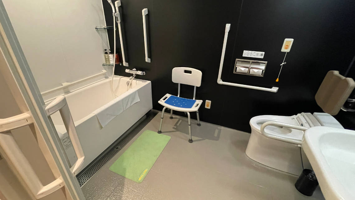 Unit bath with bath tub, shower chair and toilet