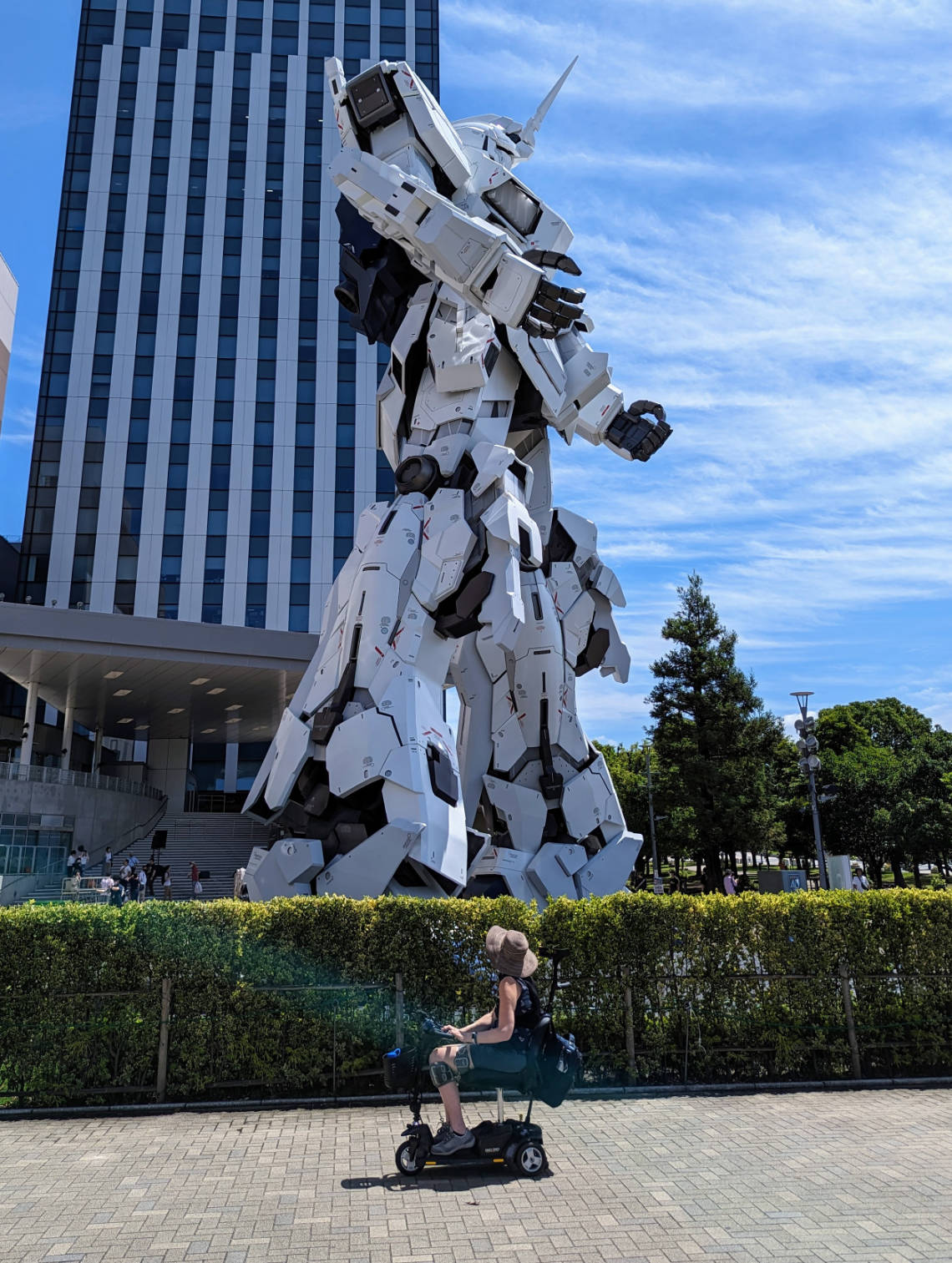 Anne de Ridder in her mobility scooter with a giant Gundam