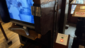 Video display with a button to play content and a QR code for audio translation