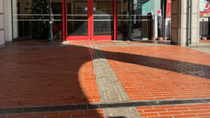Tactile pavement on a red brick walkway leading to the guest center at the top of the Kobe Nunobiki Herb Gardens ropeway.