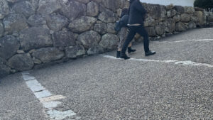 A steep pathway bordered by stone walls inside the castle grounds, which may be challenging for those with mobility issues.