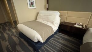 One of the beds in the accessible room is partially reclined, showing its adjustable feature.