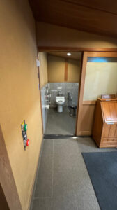 Entrance to the accessible toilet near the restaurant, with buttons to open the automatic door.