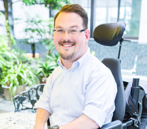 Josh Grisdale, a man in a power wheelchair